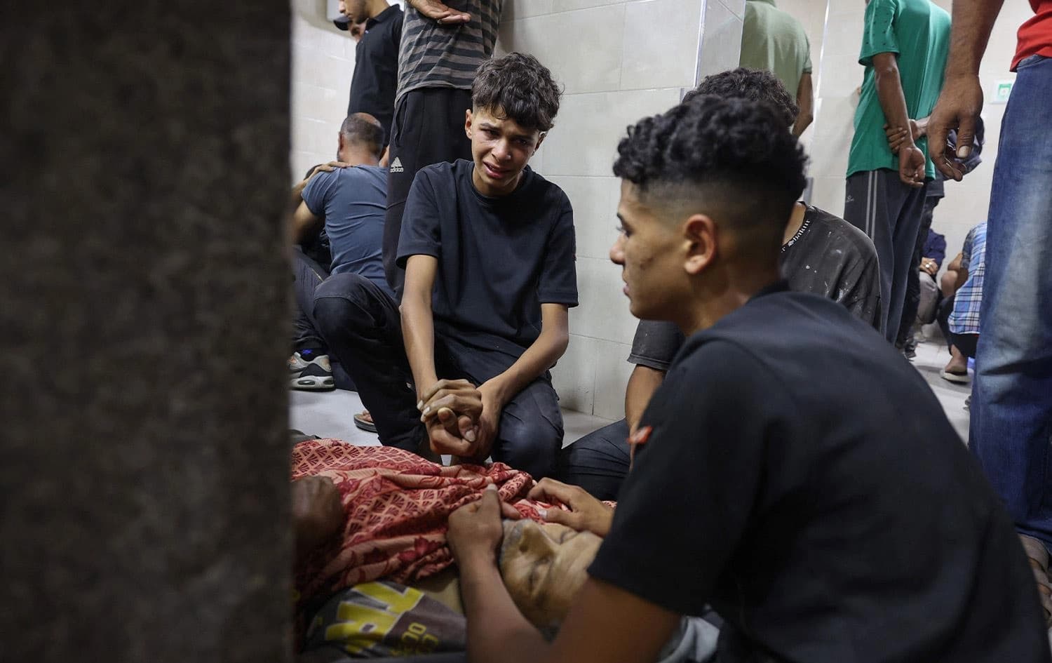 شباب فلسطينيون ينعون جثة أحد أقاربهم - AFP